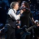 Dave Grohl, right; Nate Mendel, background left; Some other guy, left.
